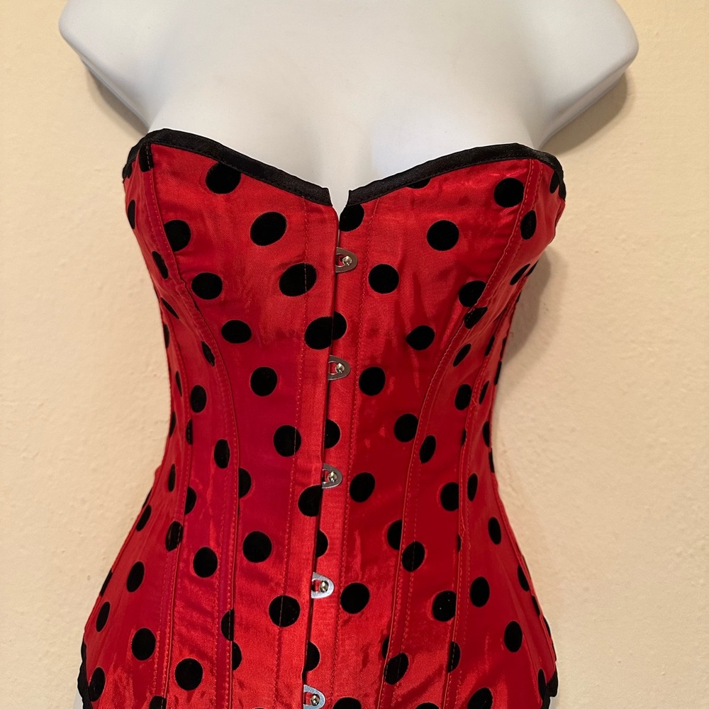 Red corset with black polka dots and matching g string. Ladybug 🐞 runs small.